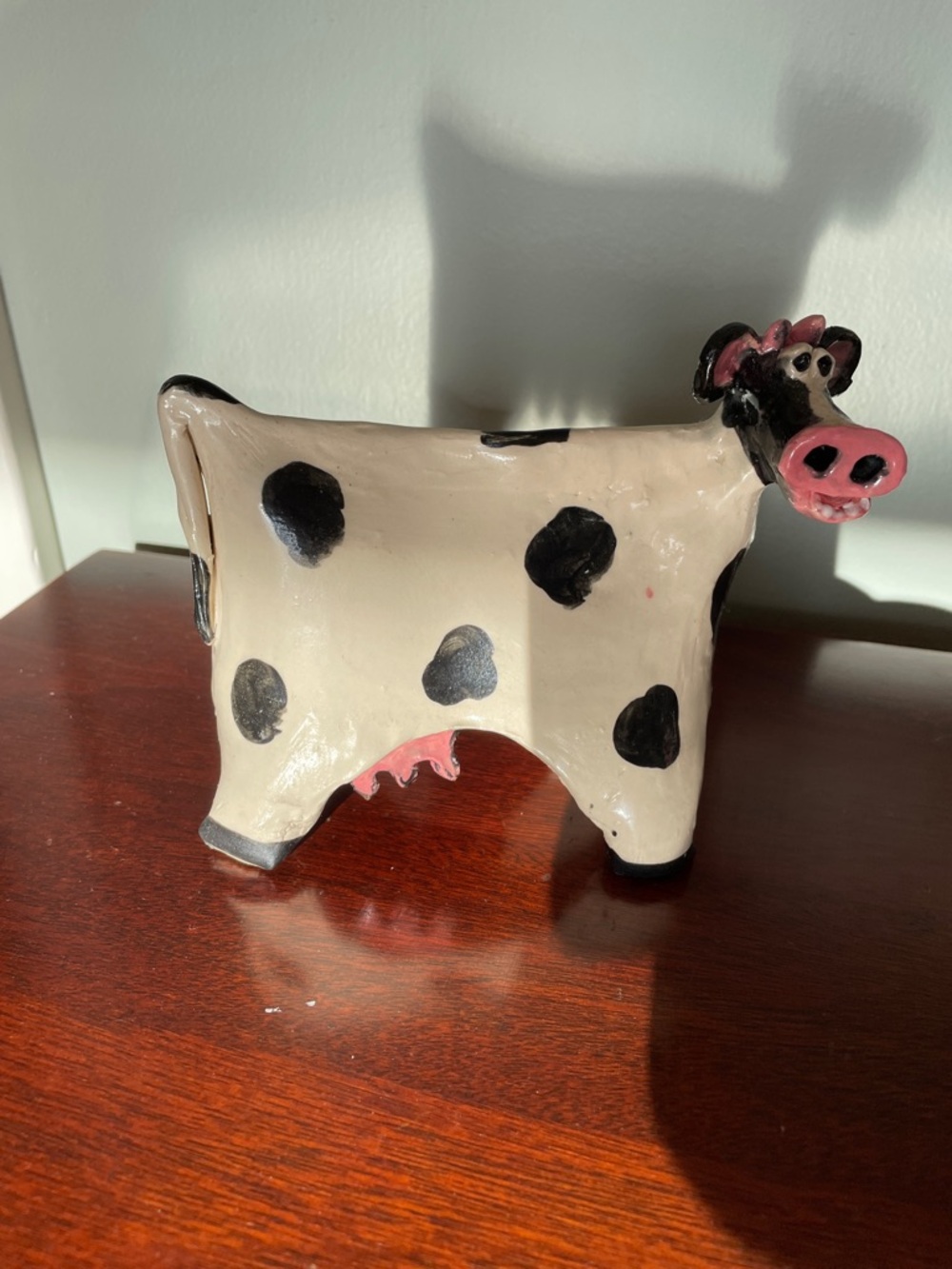Handcrafted Cream & Black Ceramic Cow Figurine with Pink Accents